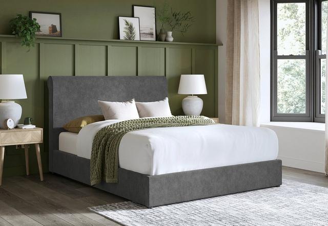 Two people carring a mattress off a Dreams delivery van.