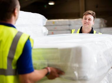 Delivery team lifting a mattress