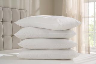 4 supple silentnight pillows stacked on a bed