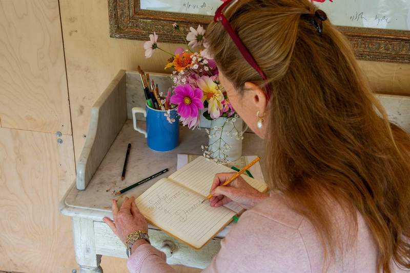 Sophie Conran writing in a journal