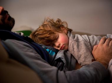 Child sleeping on their parent