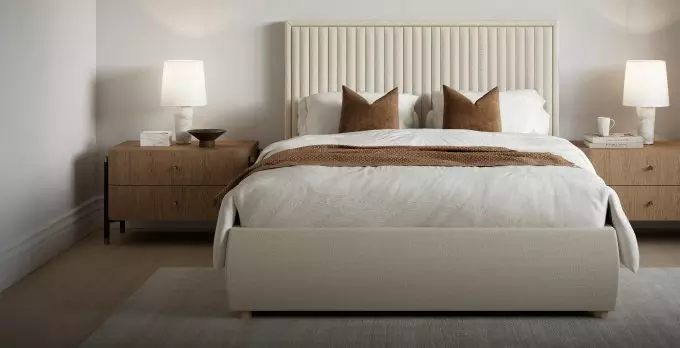 Grey divan bed in a bedroom setting.