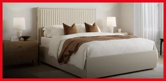 White ottoman bed in a bedroom setting.