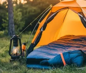 Image of a blue sleeping bag in an outdoor orange tent.