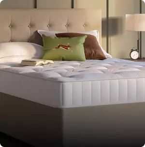 Dingwall mattress on a cream colored bed frame.