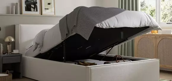 Image of a white storage bed with lifted slat.