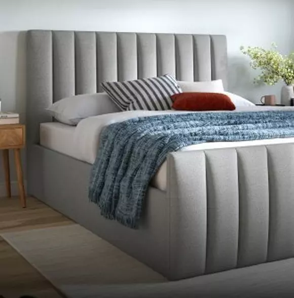 Grey bed frame in a bedroom setting.