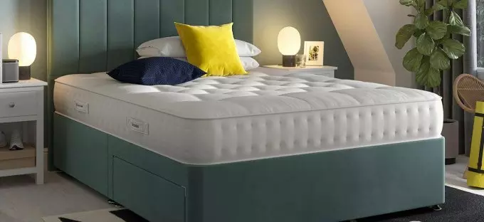 Green divan in a bedroom setting as background image.