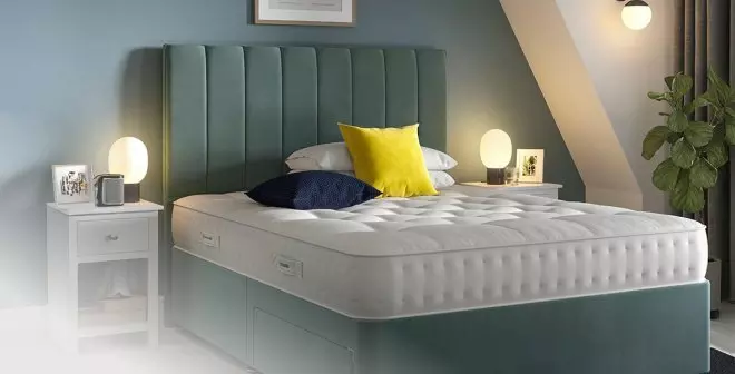 Green divan bed in a bedroom setting.