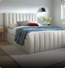 Image of a white bedframe in a bedroom