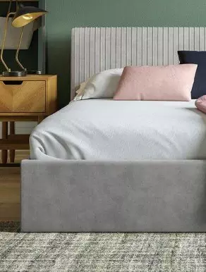 Grey bedframe in a bedroom setting