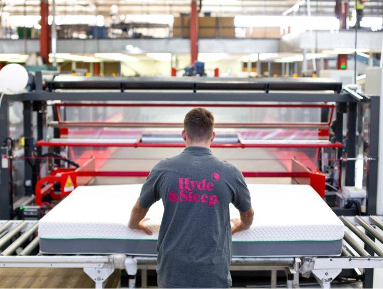 A hyde-and-sleep bed frame with a hyde-and-sleep mattress, set in a bedroom