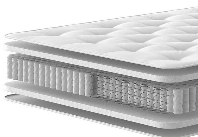 Two people carring a mattress off a Dreams delivery van.