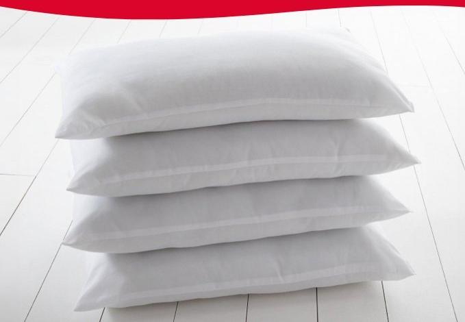 4 White Silentnight Pillows Stacked Over Eachother 
