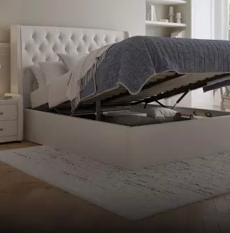 White ottoman bed in a bedroom setting as card background.